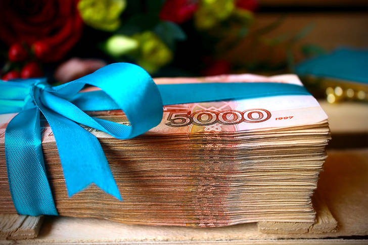 A bundle of banknotes tied with a ribbon