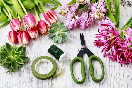 Spring flowers and scissors on the table