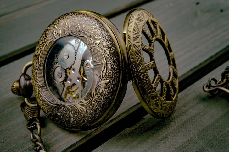 Vintage clock on a wooden background