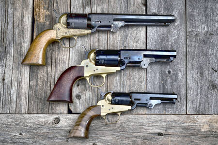 Revolvers on a wooden background