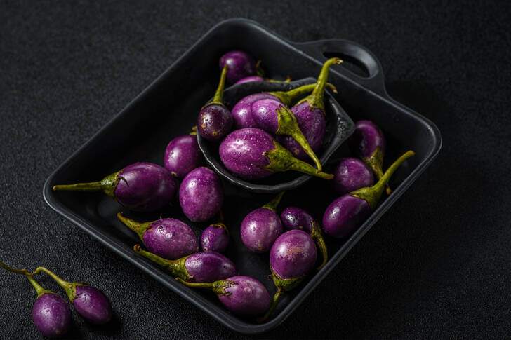 Mini eggplants on a black table
