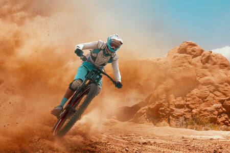 A cyclist on a sandy road