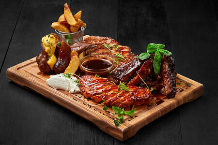 Grilled meat platter with potato wedges