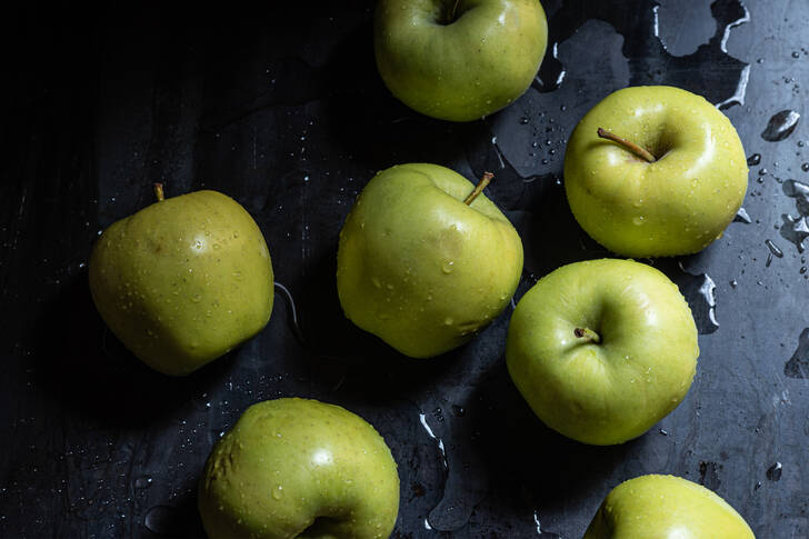 Green apples on a black background