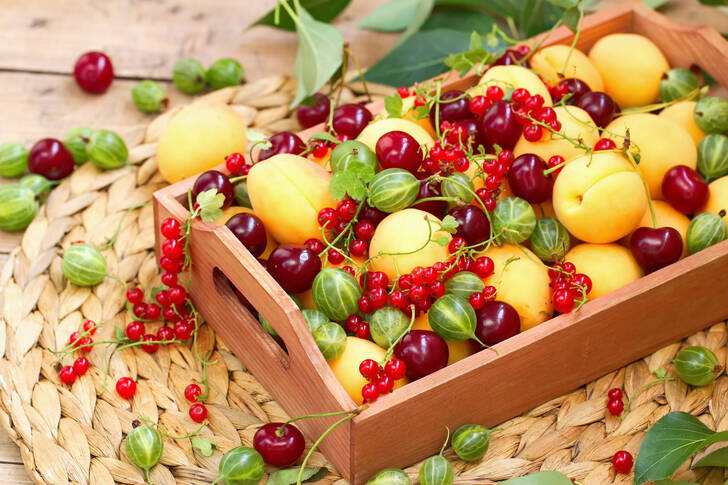 Berries and fruits on a wooden tray