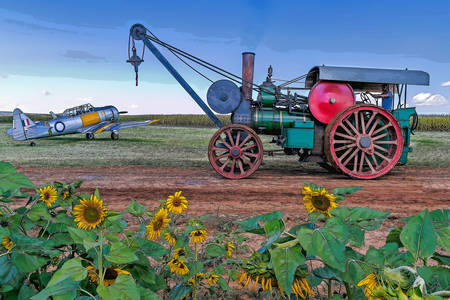 Steam tractor and airplane in the field