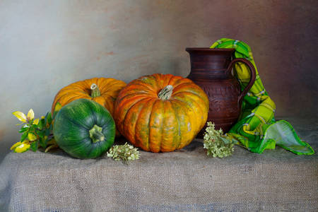 Pumpkins and a jug on the table