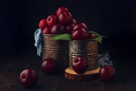 Red plums in mugs