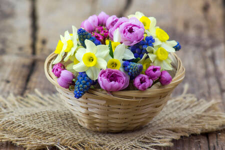 Bouquet of spring flowers in a basket