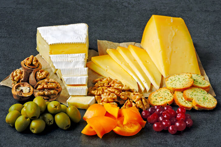 A selection of cheeses, berries, nuts