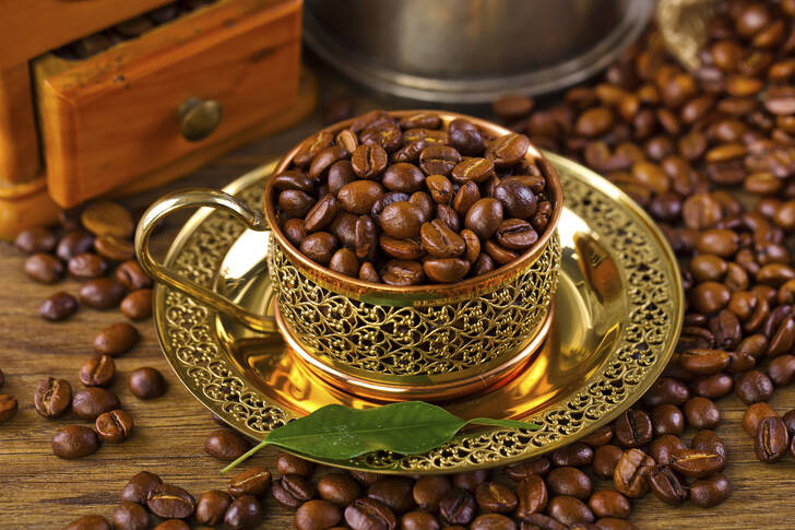 Coffee beans in a gold cup