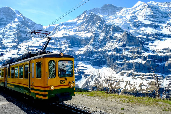 Yellow train in the mountains of Switzerland
