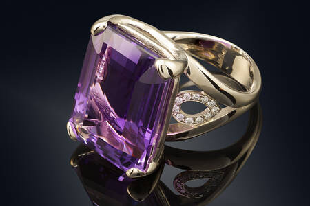 Ring with amethyst on a black background