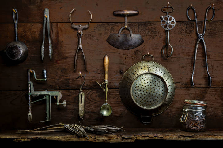 Old kitchen utensils on a wooden wall