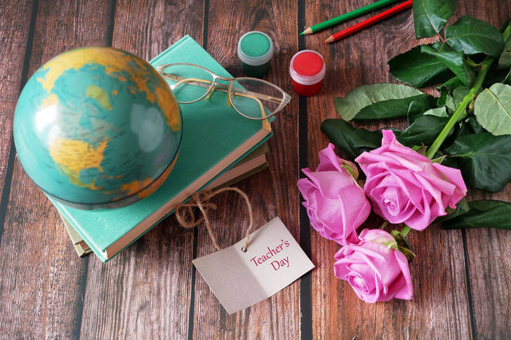 Books, globe and roses on the table