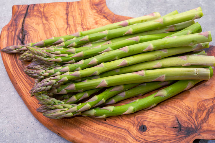 Green asparagus on a wooden board