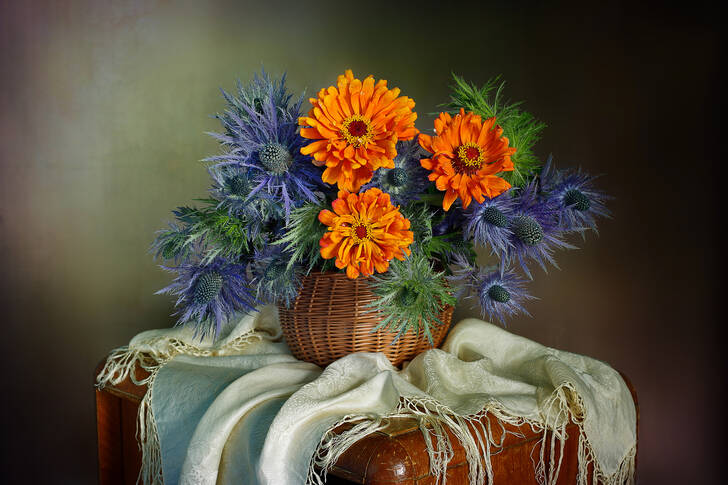 A bouquet with orange and blue flowers