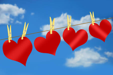 Red hearts on blue sky background