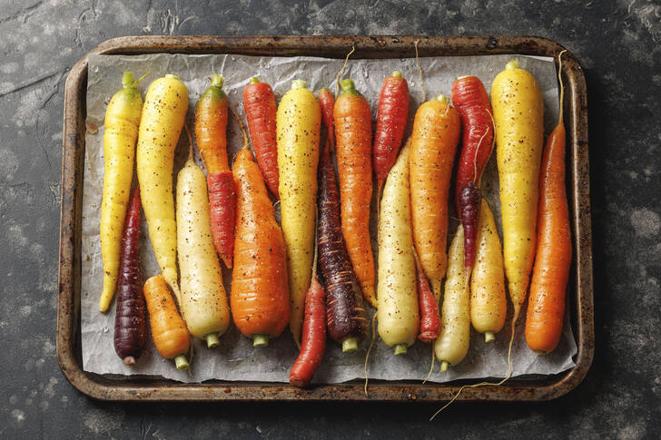 Multicolored carrots on a baking sheet